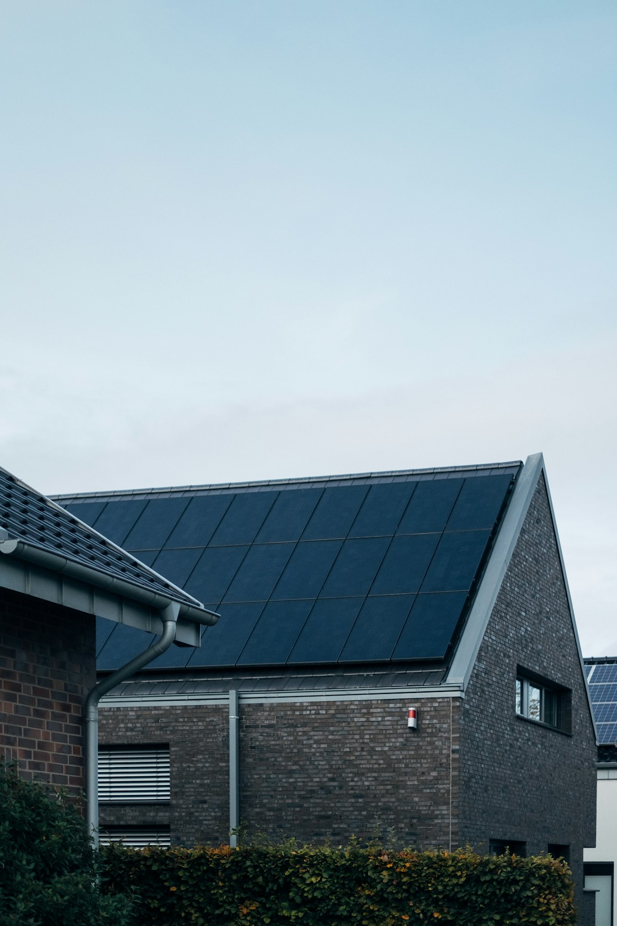 Modern UK home with all-black solar panels fitted flush to a south-facing roof