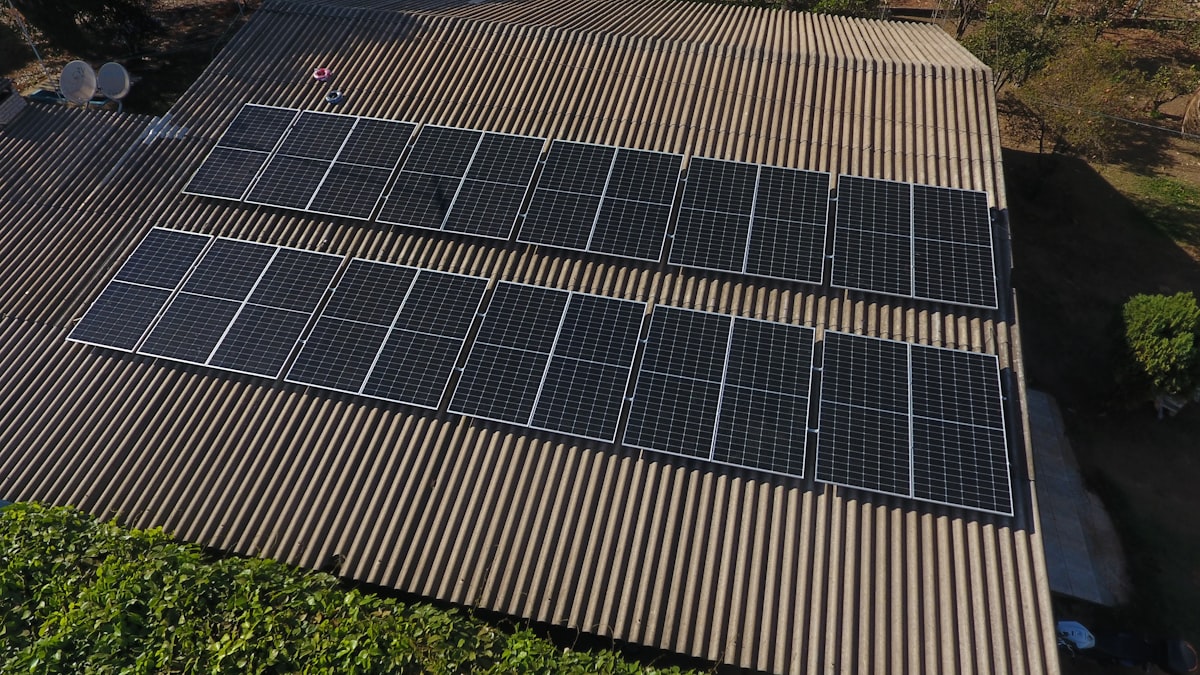Aerial view of a rooftop array of solar panels installed in two rows