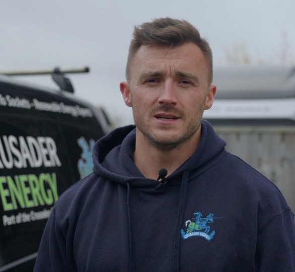 Jonny, founder of Crusader Energy, in branded hoodie outside Benton workshop